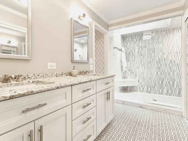 a bathroom with a granite countertop sink and a bathtub
