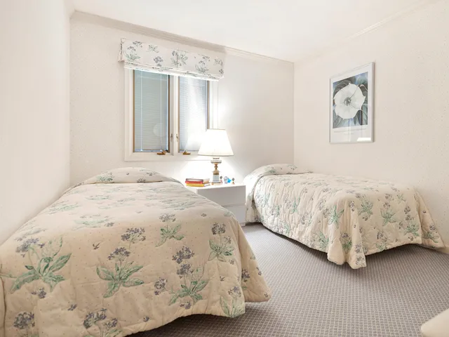 a bedroom with two beds and a window