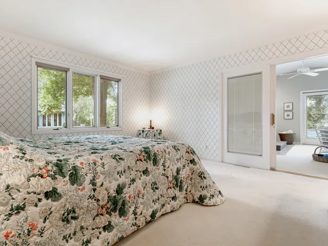 a spacious bedroom with a bed and a couch