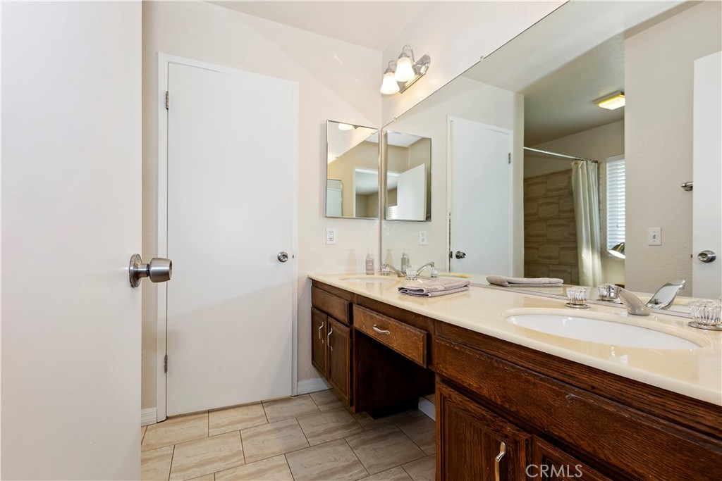 8527 Hillside Road Rancho Cucamonga, CA 91701 - Photo 28 of 50 a bathroom with a sink and a mirror
