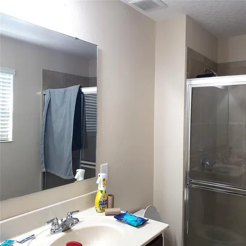 a bathroom with a shower and a vanity