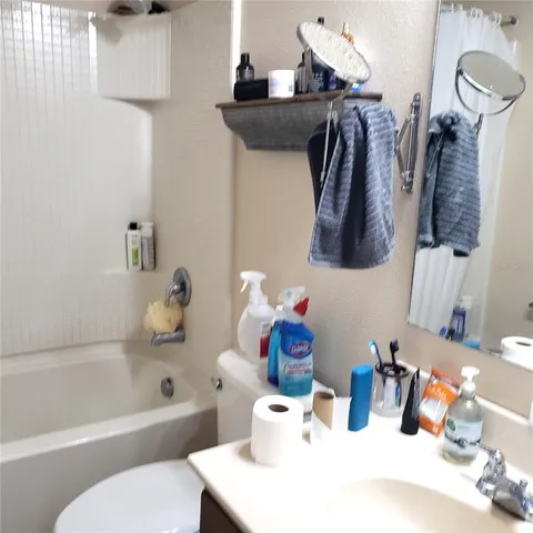 a bedroom with bed and a mirror