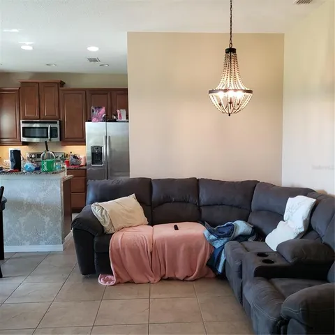 a living room with furniture and kitchen view