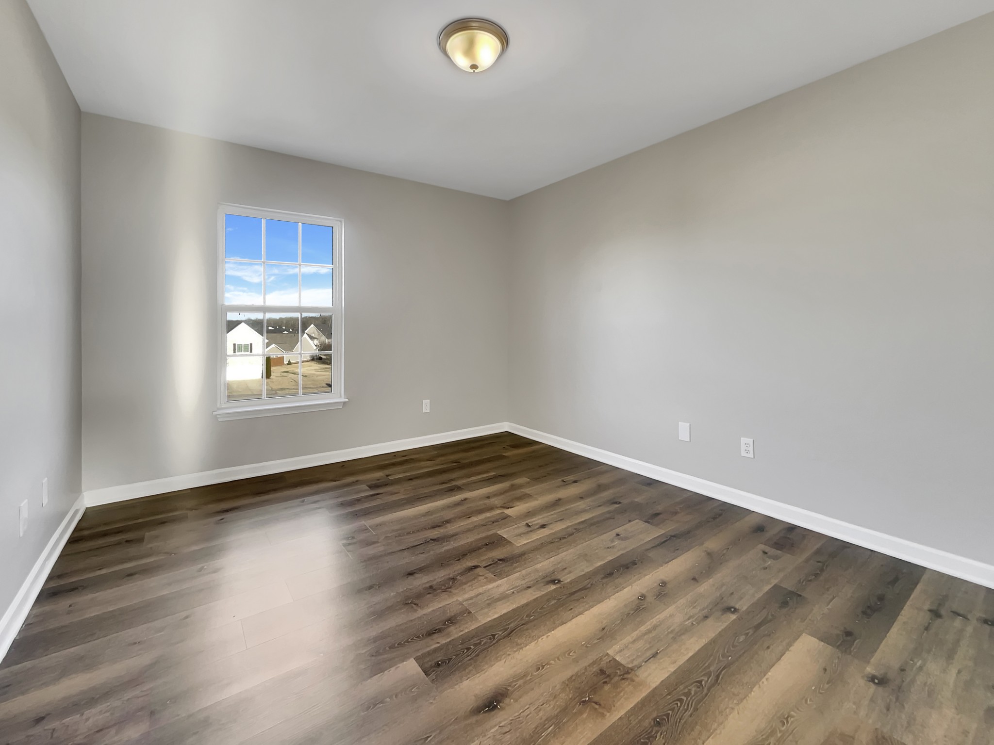 2033 Red Jacket Trace Spring Hill, TN 37174 - Photo 12 of 20 an empty room with wooden floor and windows