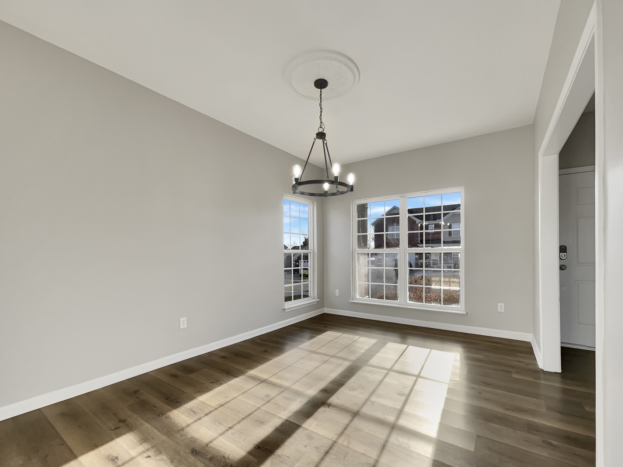 2033 Red Jacket Trace Spring Hill, TN 37174 - Photo 7 of 20 a view of empty room with wooden floor and windows