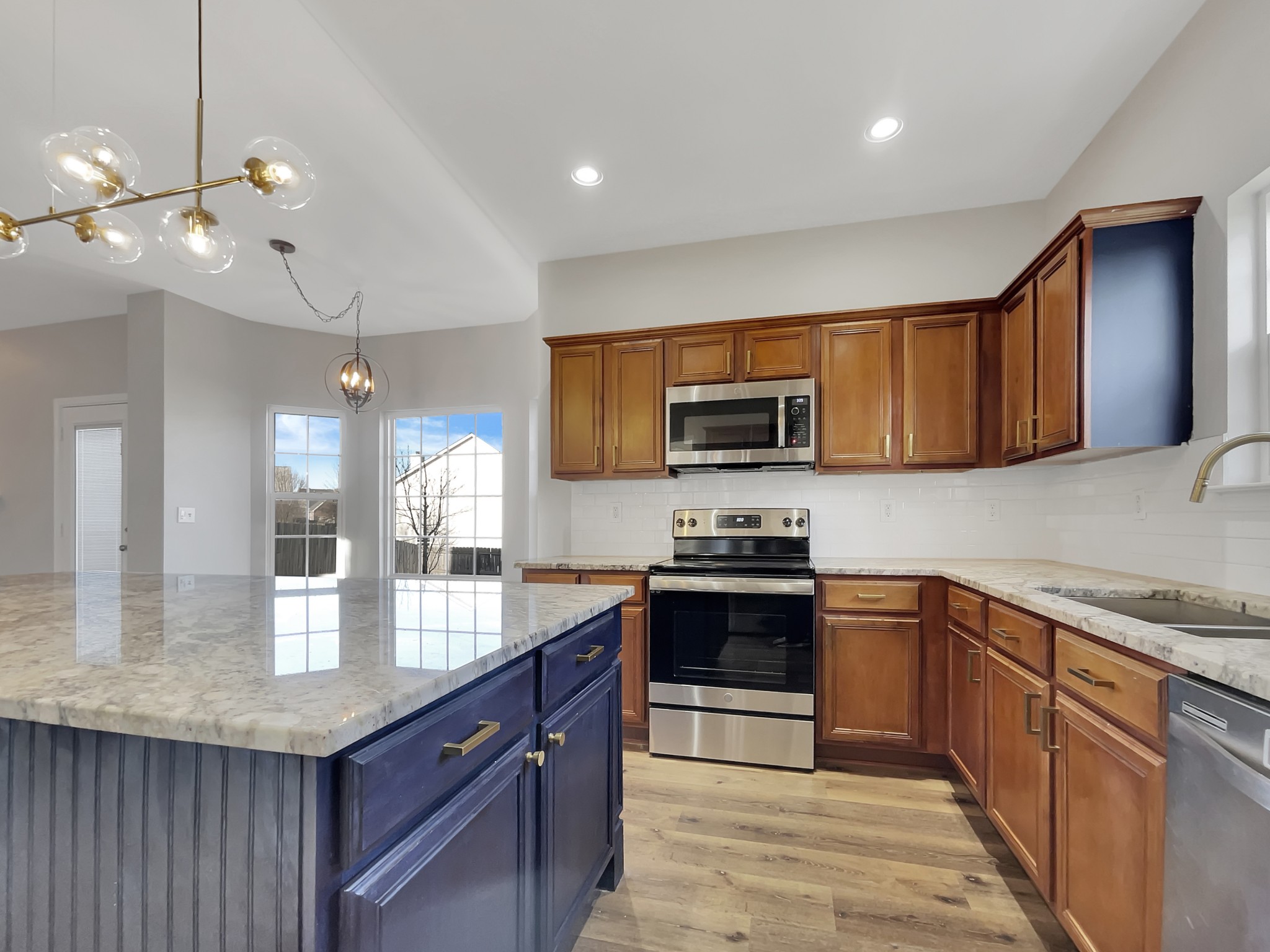 2033 Red Jacket Trace Spring Hill, TN 37174 - Photo 9 of 20 a kitchen with stainless steel appliances granite countertop wooden cabinets a granite counter tops and a hard wood floors