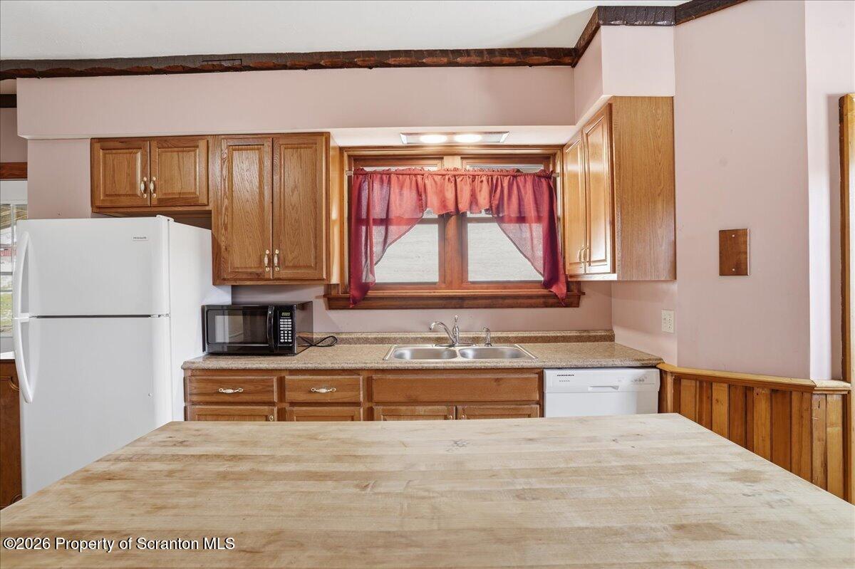 795 Wescott Road New Milford, PA 18834 - Photo 33 of 81 a kitchen with a refrigerator a stove top oven and a large window