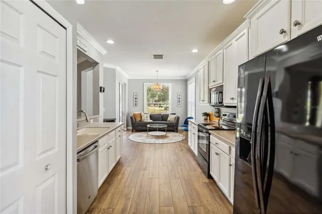 a living room with kitchen island furniture and a chandelier