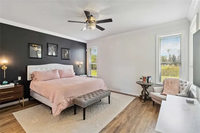 a bedroom with a bed and a table with a bookshelf