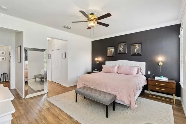 a bedroom with a bed and a chandelier