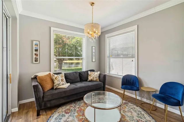 a living room with furniture a table and a chandelier
