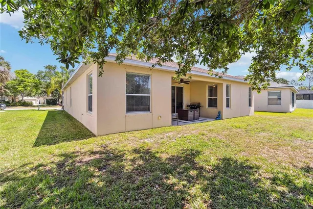 a front view of house with yard and trees