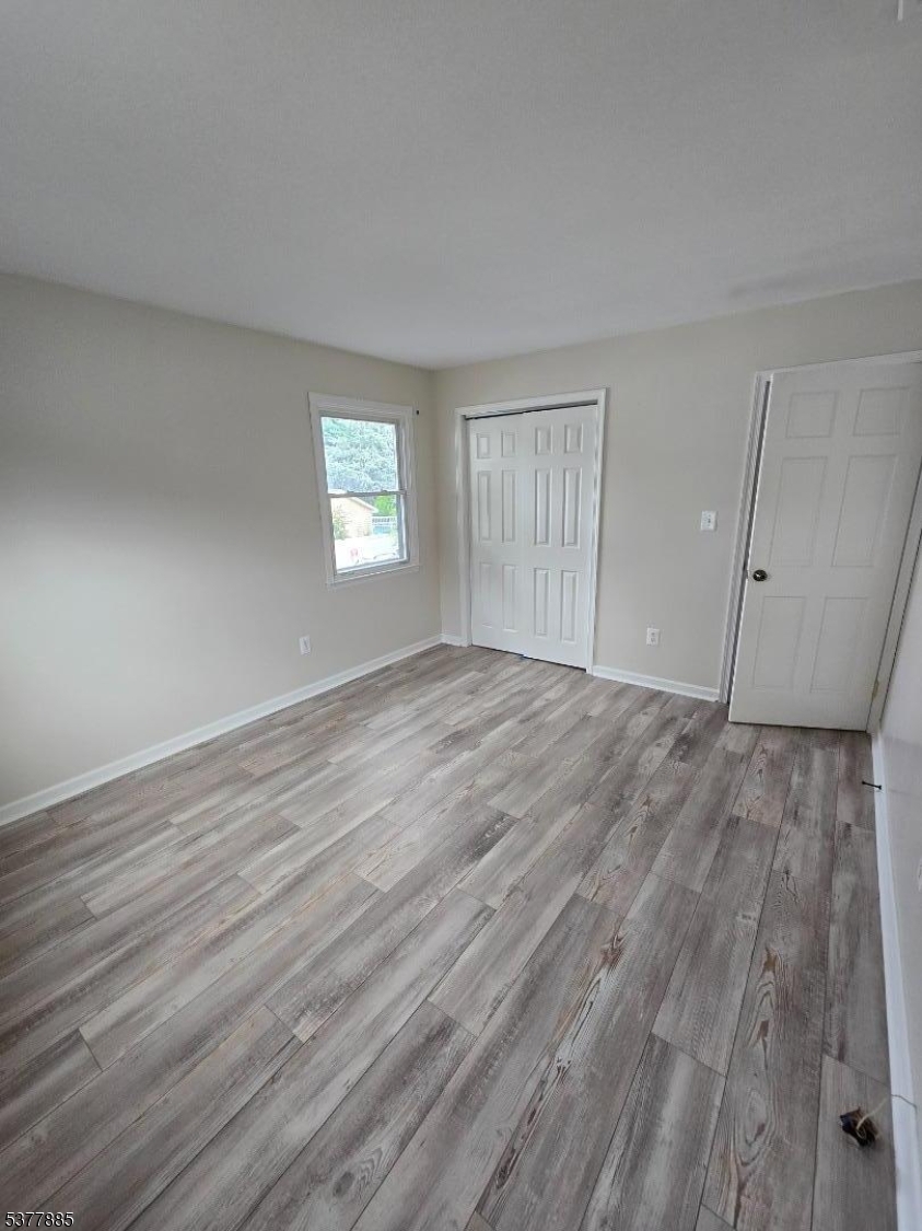759 Lafayette Avenue, Unit 2 Hawthorne, NJ 07506 - Photo 8 of 13 a view of empty room with wooden floor and fan