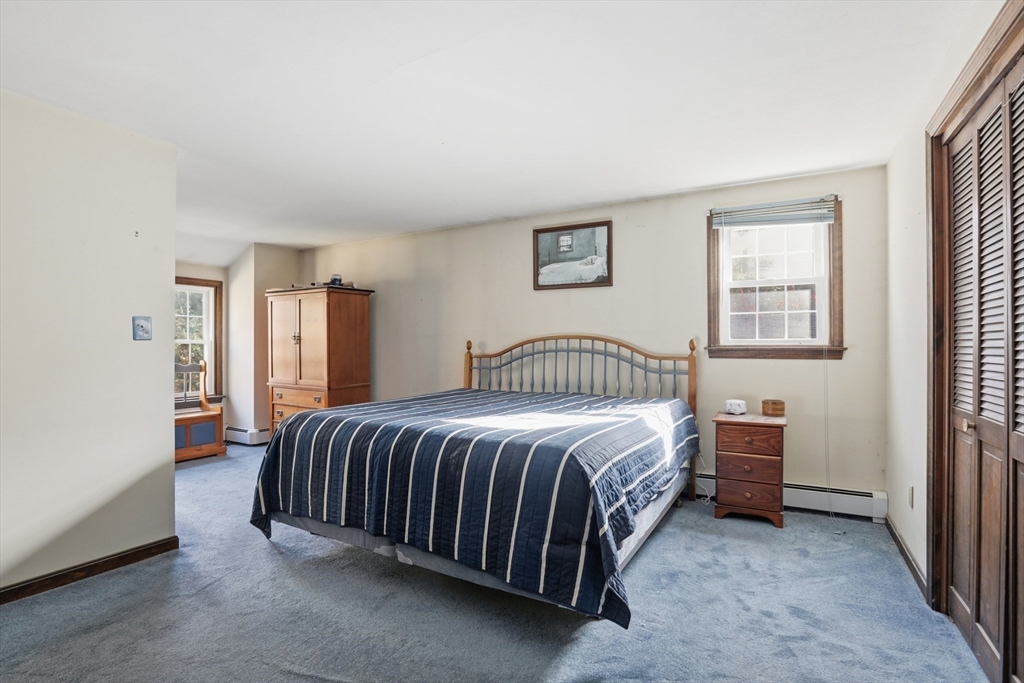 254 Ash Swamp Road Newmarket, NH 03857 - Photo 14 of 30 a bedroom with a bed and a window
