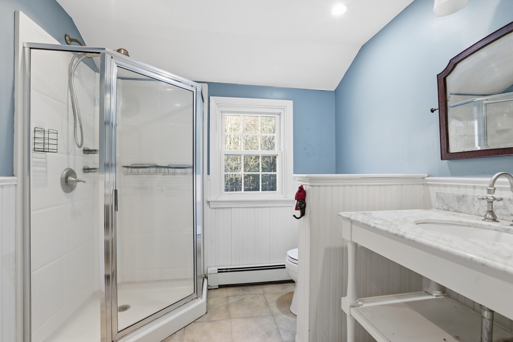 254 Ash Swamp Road Newmarket, NH 03857 - Photo 15 of 30 a bathroom with a sink and a mirror