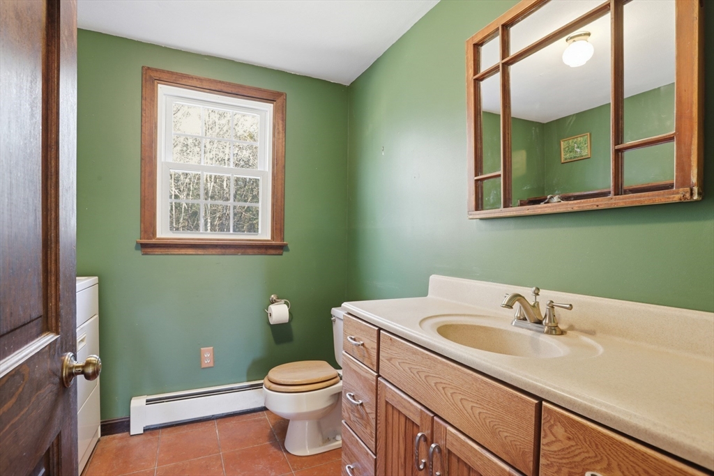 254 Ash Swamp Road Newmarket, NH 03857 - Photo 16 of 30 a bathroom with a toilet sink and mirror