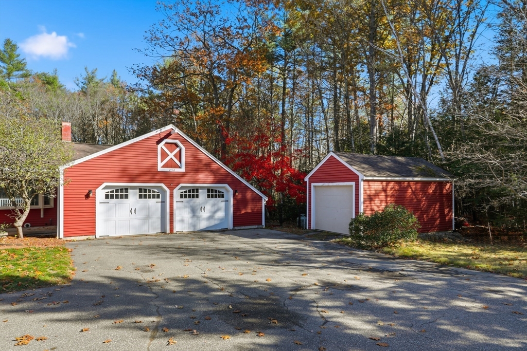254 Ash Swamp Road Newmarket, NH 03857 - Photo 24 of 30 a front view of a house with a yard and garage