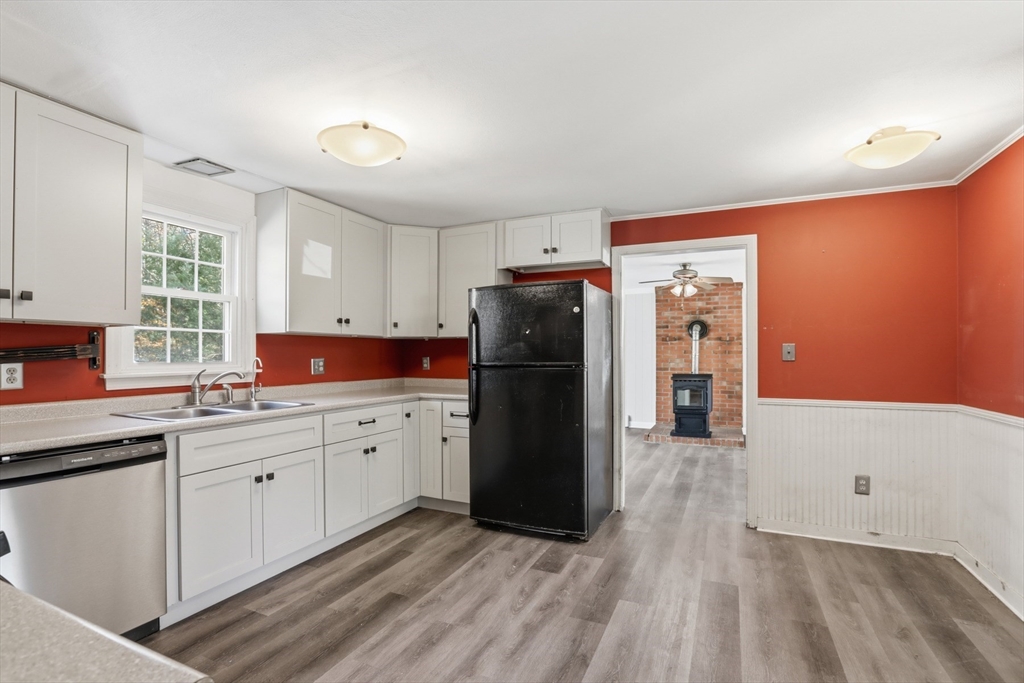 254 Ash Swamp Road Newmarket, NH 03857 - Photo 5 of 30 a kitchen with a refrigerator and a sink