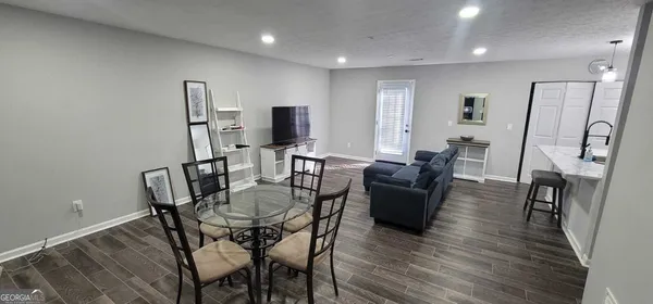 a view of a dining room with furniture and wooden floor