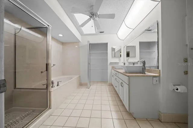 a bathroom with a glass shower door and a sink