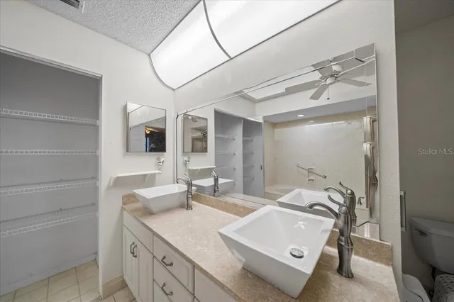 a view of a kitchen with a sink and a refrigerator