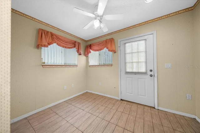 a bathroom with a granite countertop toilet sink and mirror