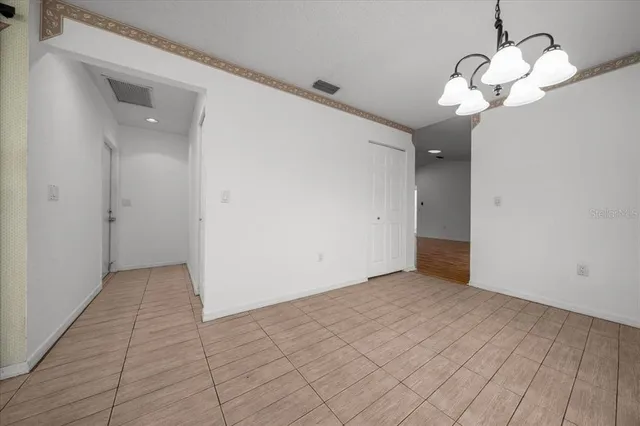 a view of a livingroom with a ceiling fan & wooden floor