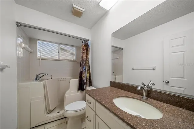 a view of a livingroom with a ceiling fan and window