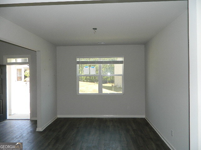 3790 River Rock Road Lithonia, GA 30038 - Photo 3 of 14 an empty room with wooden floor and windows