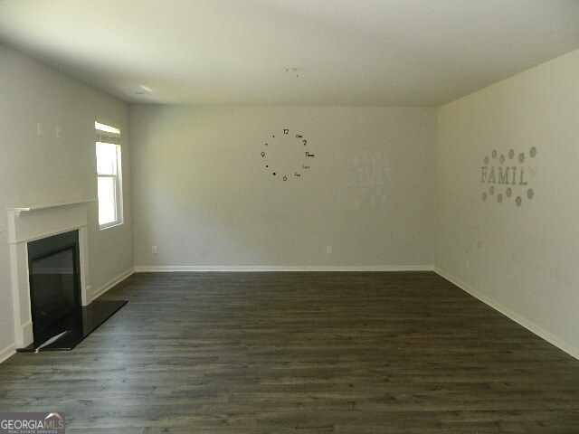 3790 River Rock Road Lithonia, GA 30038 - Photo 5 of 14 an empty room with wooden floor and windows
