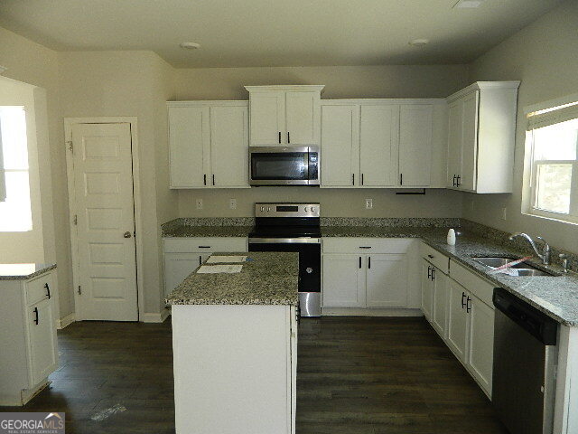 3790 River Rock Road Lithonia, GA 30038 - Photo 6 of 14 a kitchen with granite countertop a sink a stove and cabinets
