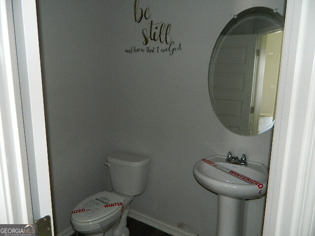 3790 River Rock Road Lithonia, GA 30038 - Photo 7 of 14 a bathroom with a toilet and a sink