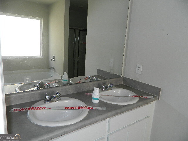 3790 River Rock Road Lithonia, GA 30038 - Photo 9 of 14 a bathroom with a sink and a mirror