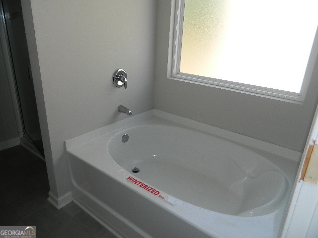 3790 River Rock Road Lithonia, GA 30038 - Photo 10 of 14 a bathroom with a bathtub