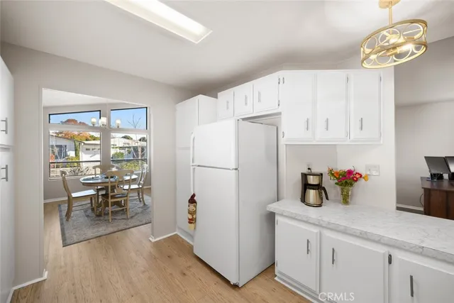 a kitchen with refrigerator cabinets and dining table