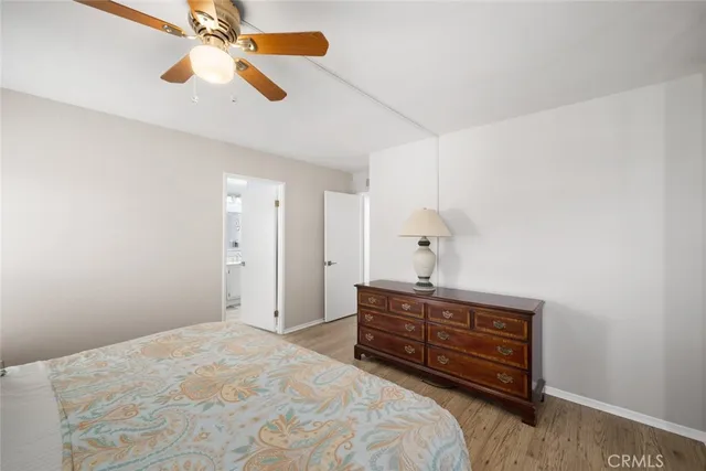 a bedroom with a bed and a chandelier fan