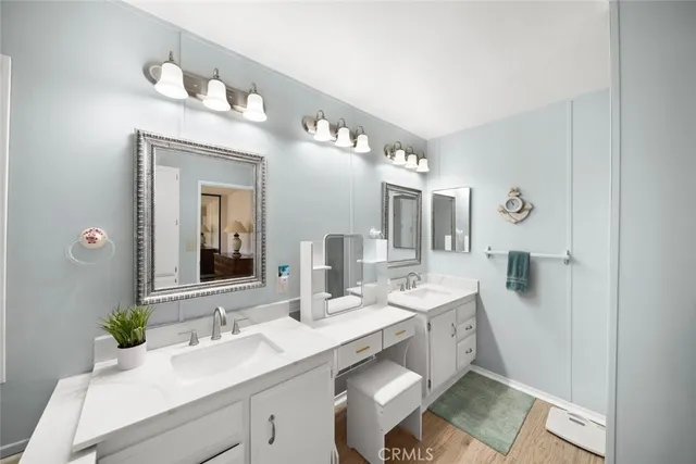 a bathroom with a granite countertop sink mirror and vanity
