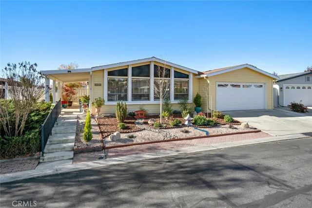 a view of a house with sitting area and garden