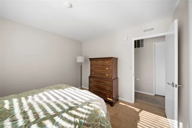 a bedroom with a bed and cabinets