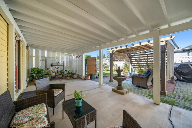a living room with furniture and potted plants