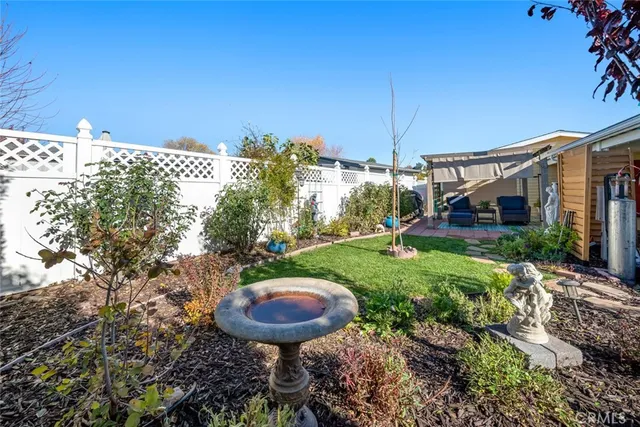 a view of a backyard with plants and a patio