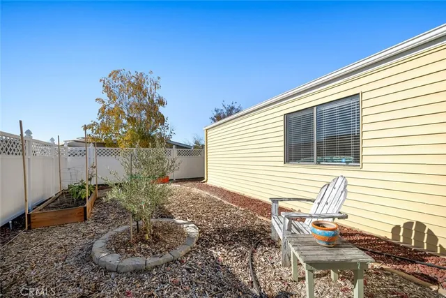 a view of a backyard with plants and outdoor seating