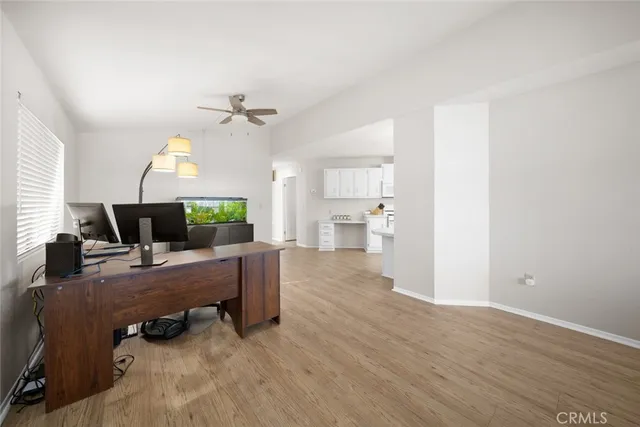 a view of a workspace with furniture and a chandelier