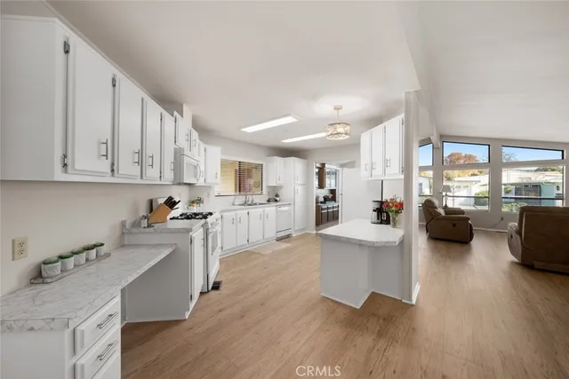 a view of a kitchen with furniture and wooden floor