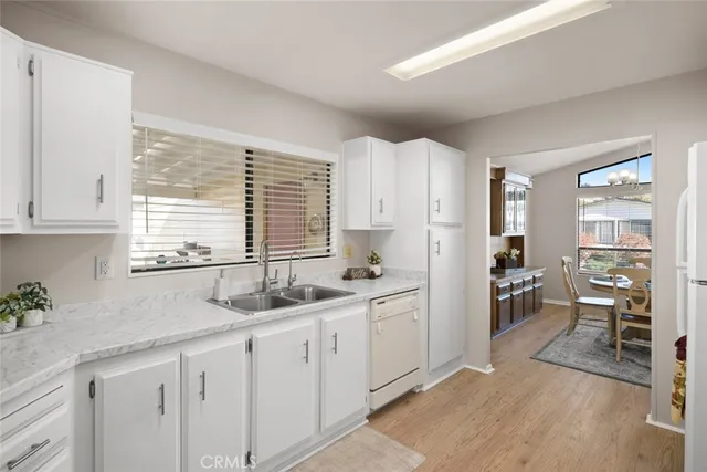 a kitchen with a sink a counter top space and cabinets