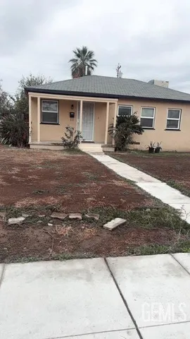a front view of a house with a yard and a garage