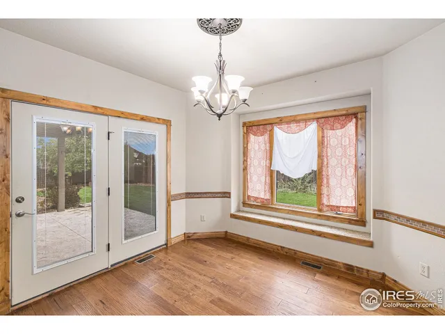 a big room with chandelier fan and windows