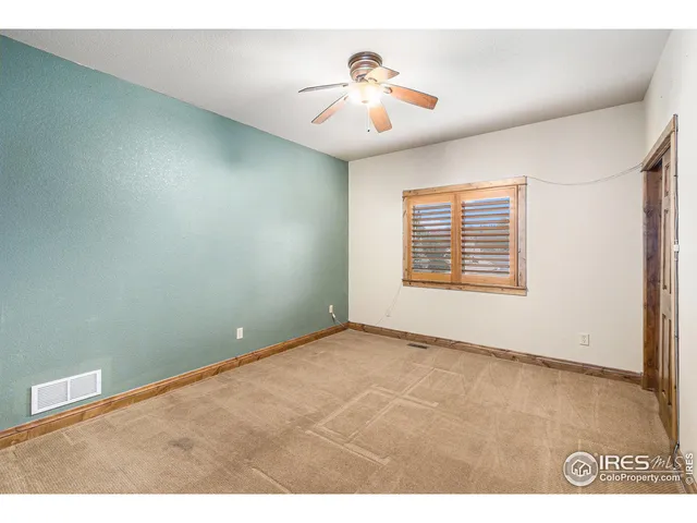 a front view of house with yard and car parked
