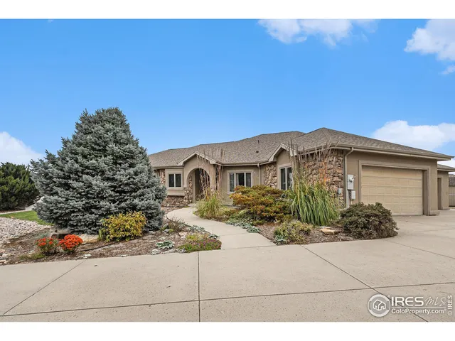 a kitchen with granite countertop a sink a counter top space and living room area