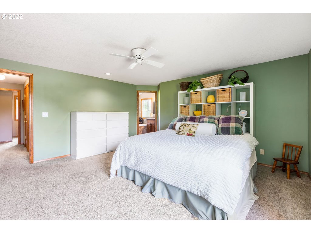 3720 Northeast 160th Street Ridgefield, WA 98642 - Photo 17 of 32 a bed room with a bed and a large mirror